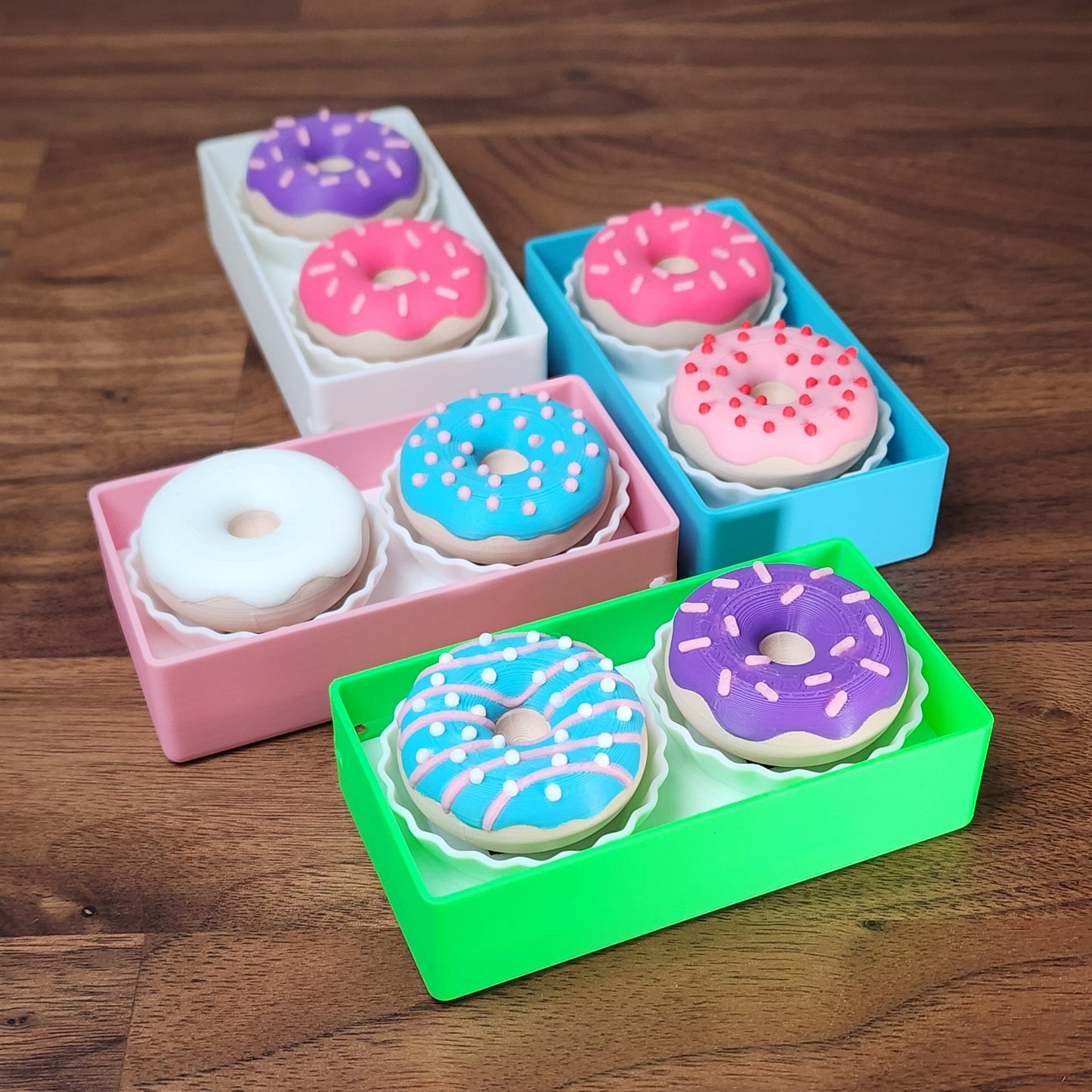 An assortment of 2 donut fidget clickers in a box
