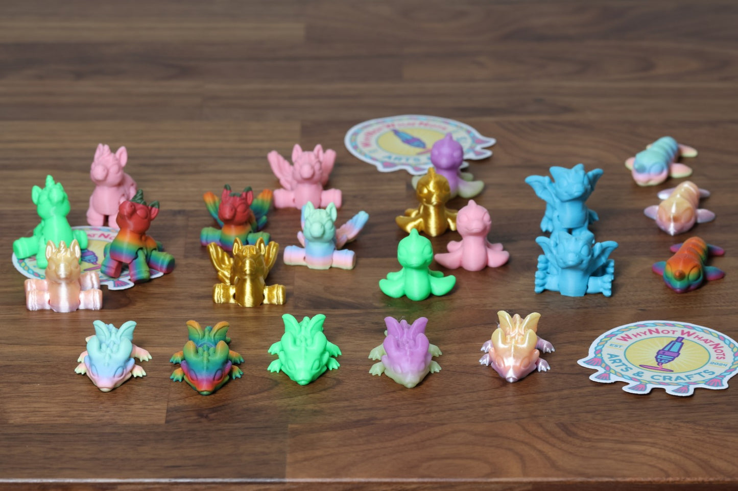 Colourful 3d printed hatchling figures on a wooden desk