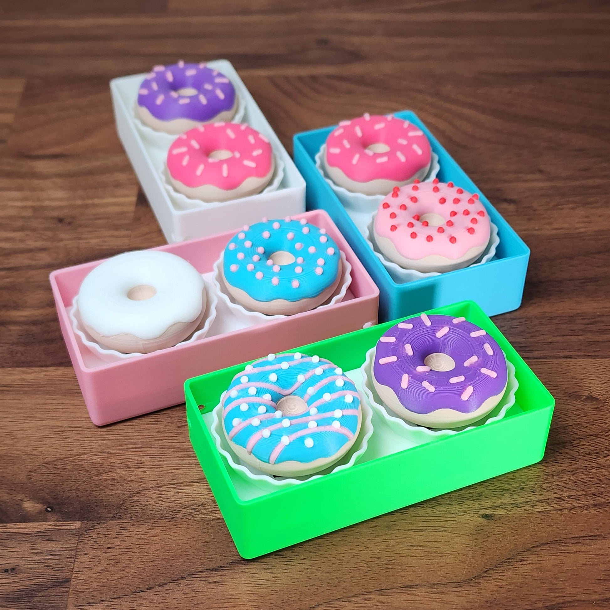An assortment of 2 donut fidget clickers in a box