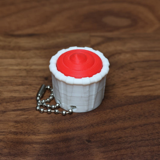 A 3d printed fidget clicker in the shape of a condiment cup that looks like it is filled with ketchup