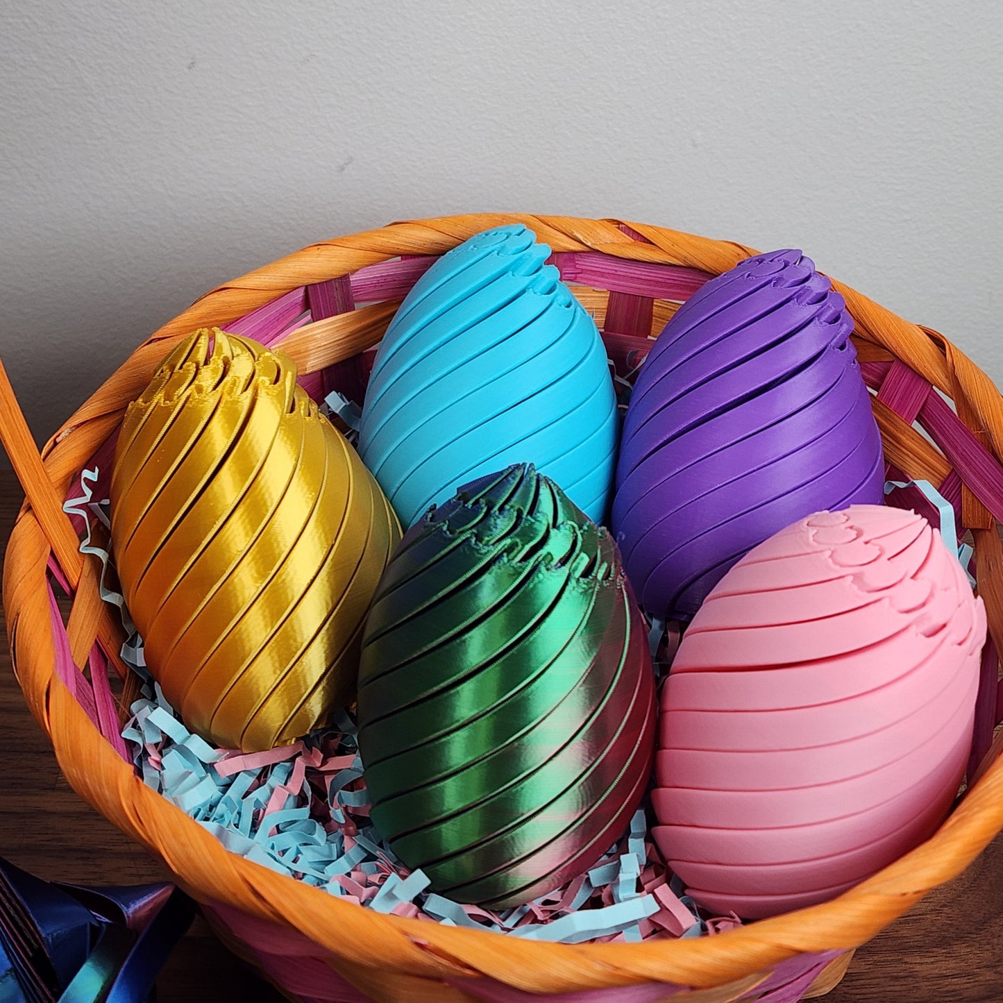 A basket filled with colourful twisty fidget Easter eggs