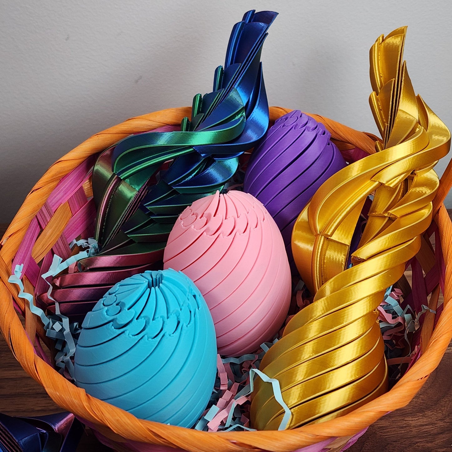 A basket full of colourful twisty fidget Easter eggs, and some fully expanded